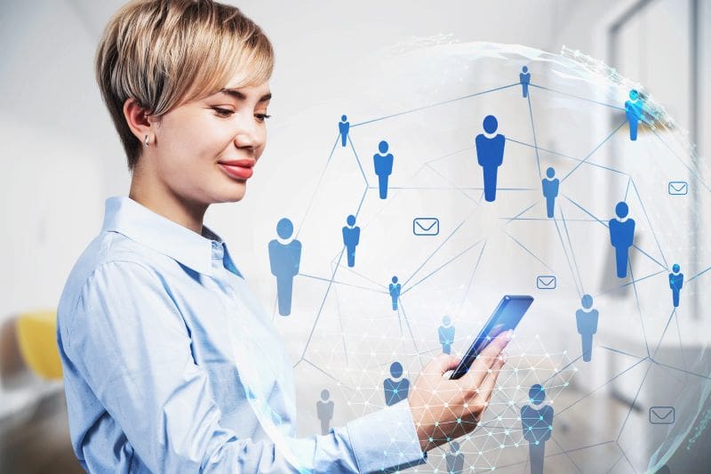 photo of a businesswoman smiling and using a CRM