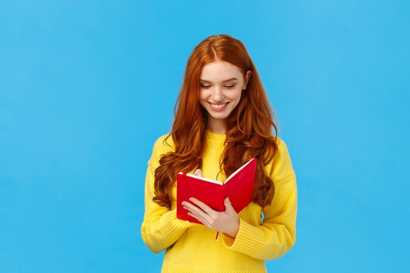 Young woman with a notebook, possibly organizing for a celebration